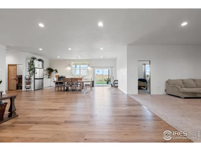 a living room with furniture and kitchen view