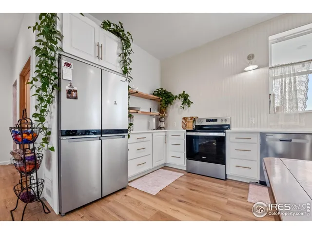 a kitchen with white cabinets and white appliances