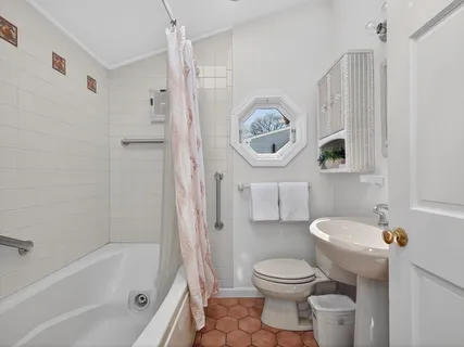 a bathroom with a sink a toilet and a tub