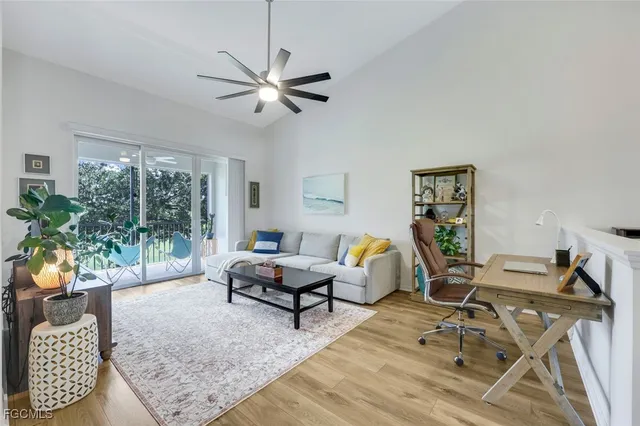 a living room with furniture and a floor to ceiling window
