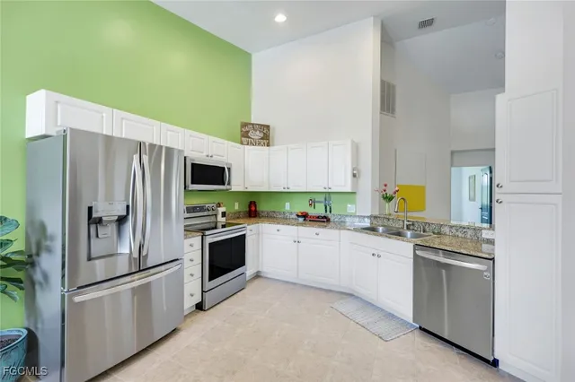 a kitchen with stainless steel appliances a refrigerator sink and stove