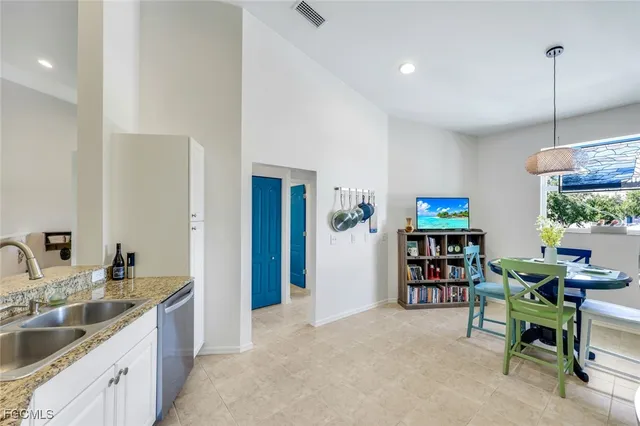 a kitchen with stainless steel appliances granite countertop a sink and a refrigerator