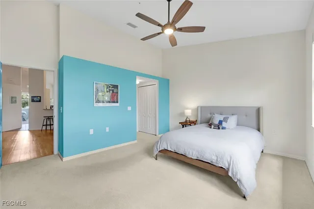 a bedroom with a large bed and a chandelier