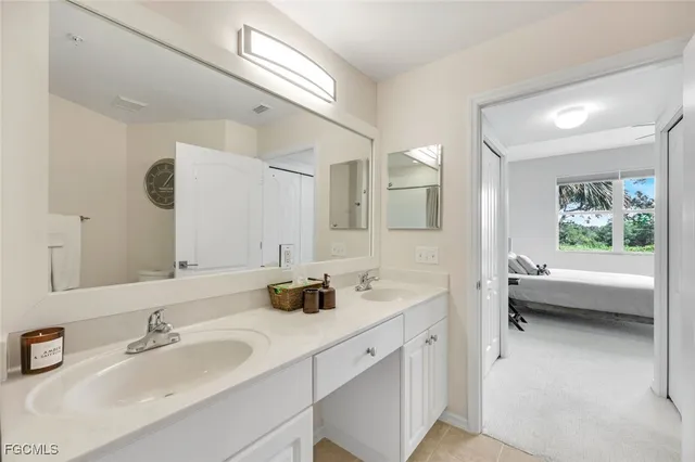 a bathroom with a tub a sink and mirror