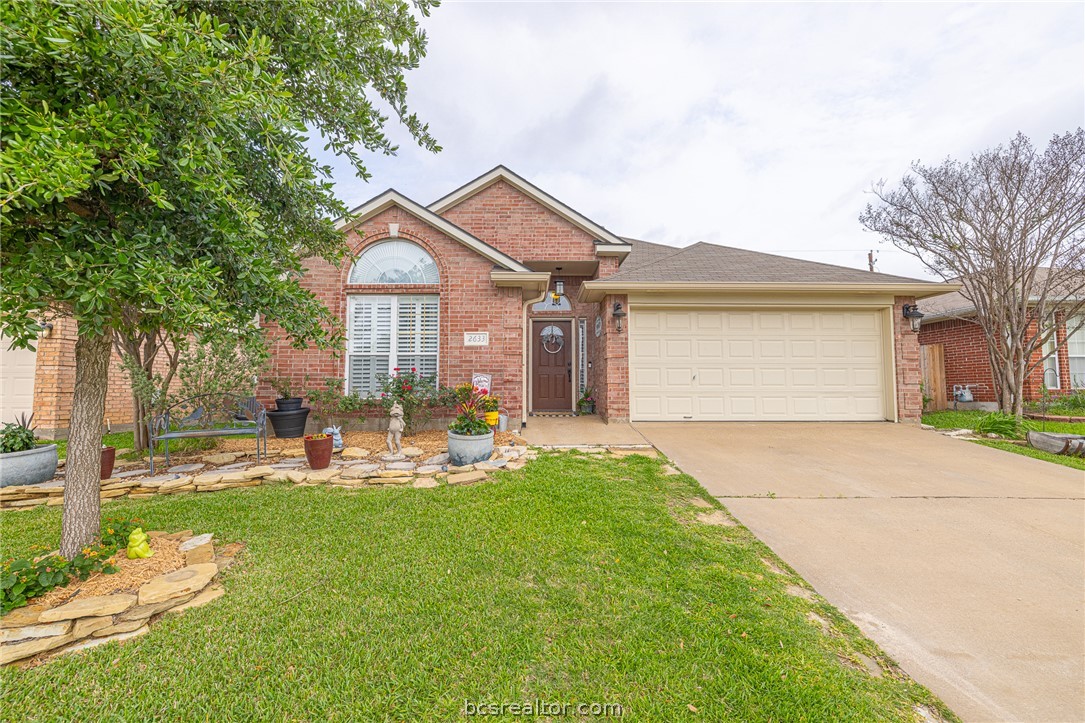 2633 Trophy Drive Bryan, TX 77802 - Photo 1 of 47 a backyard of a house with garden and outdoor seating