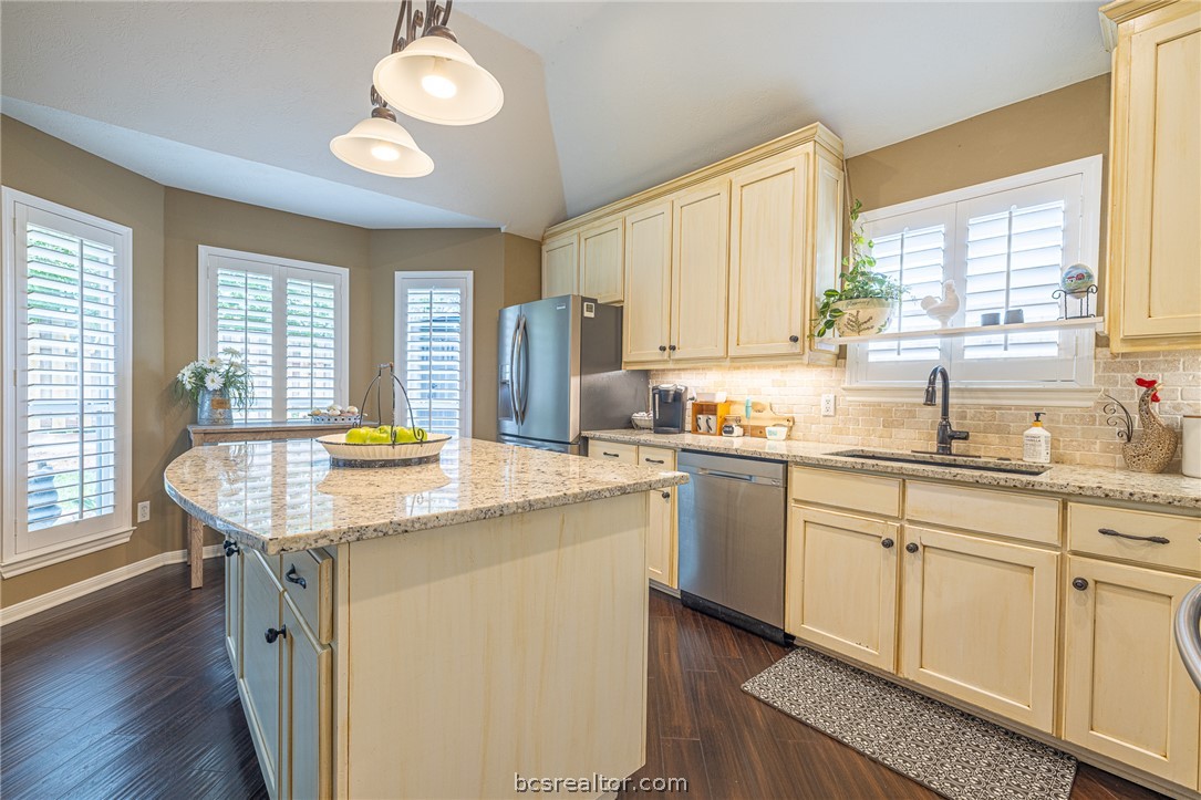 2633 Trophy Drive Bryan, TX 77802 - Photo 15 of 47 a kitchen with stainless steel appliances granite countertop stove top oven and cabinets