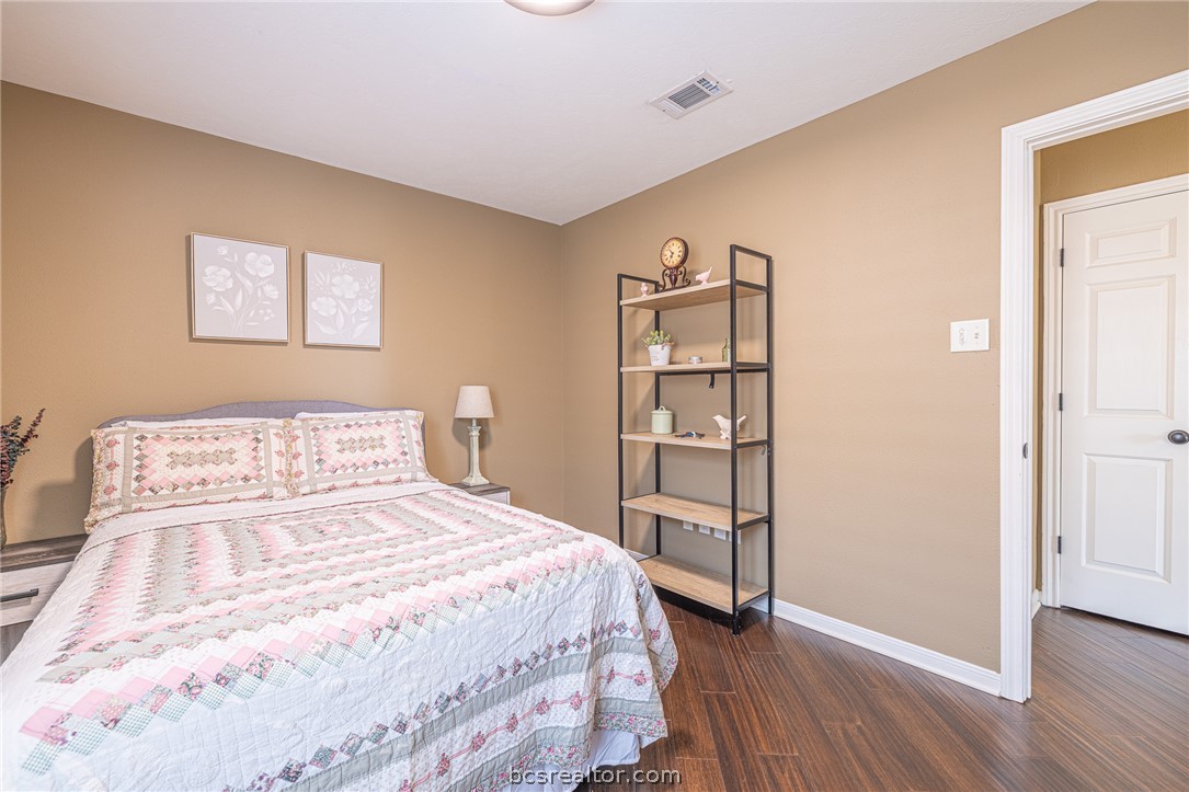 2633 Trophy Drive Bryan, TX 77802 - Photo 26 of 47 a bedroom with a bed and a wooden floor