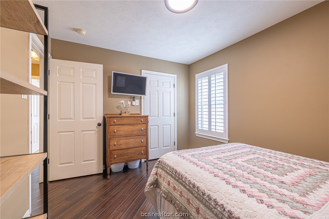 2633 Trophy Drive Bryan, TX 77802 - Photo 27 of 47 a bedroom with a bed and wooden floor