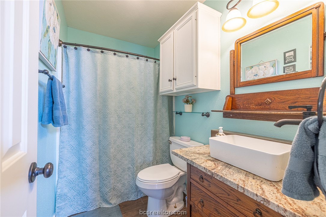 2633 Trophy Drive Bryan, TX 77802 - Photo 28 of 47 a bathroom with a sink a toilet and shower