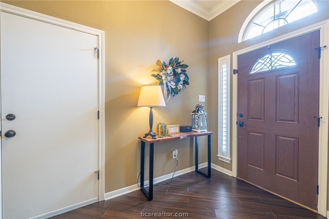 2633 Trophy Drive Bryan, TX 77802 - Photo 30 of 47 a view of a hallway with wooden floor and a bathroom