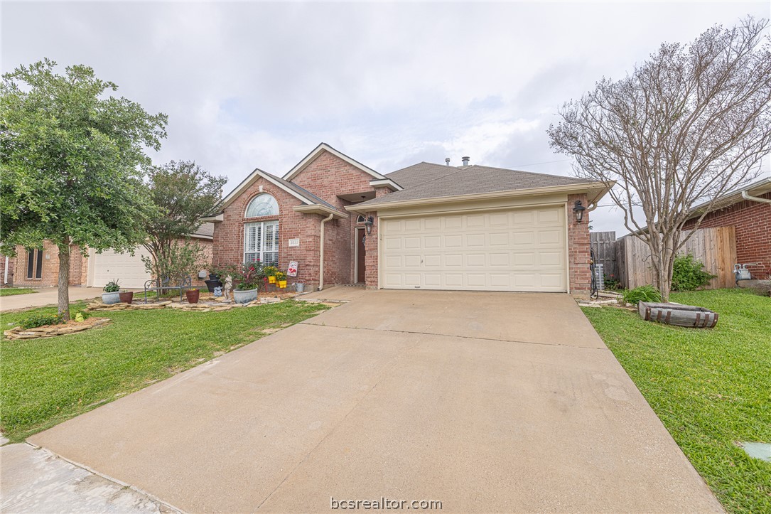 2633 Trophy Drive Bryan, TX 77802 - Photo 3 of 47 a front view of a house with a yard and garage