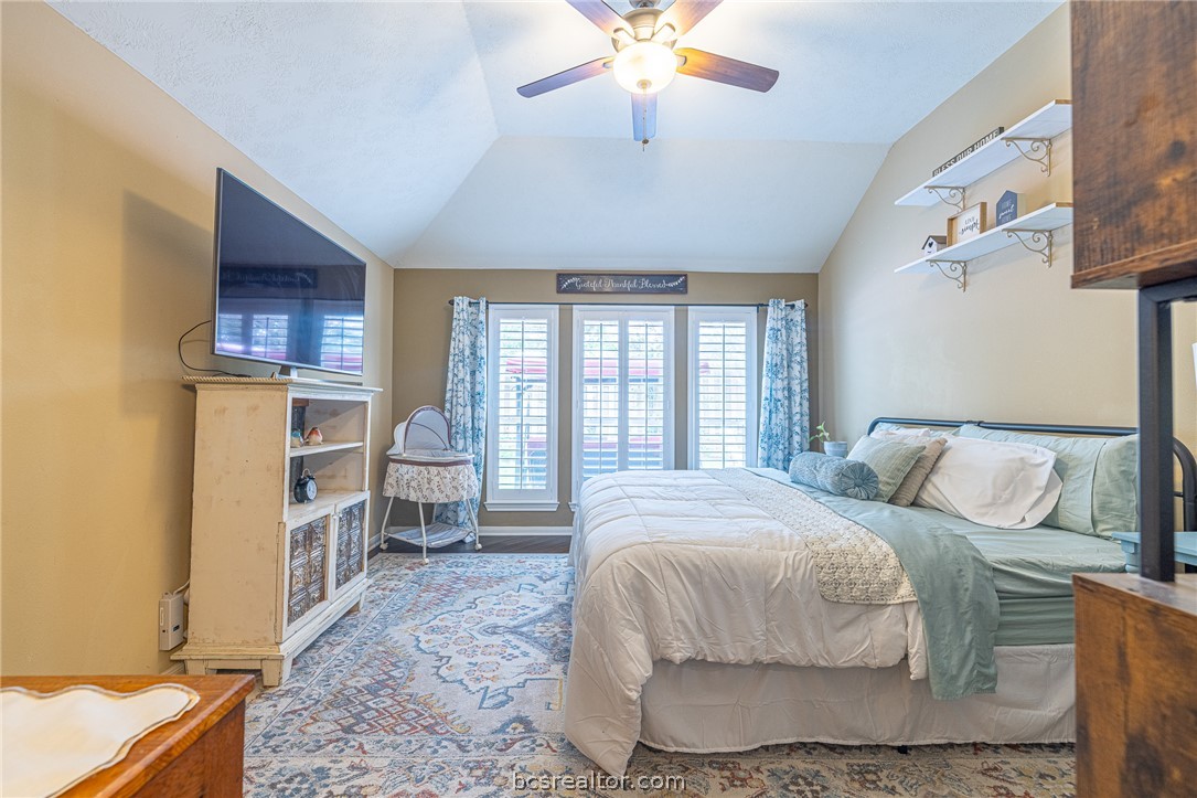 2633 Trophy Drive Bryan, TX 77802 - Photo 38 of 47 a spacious bedroom with a bed and a chandelier