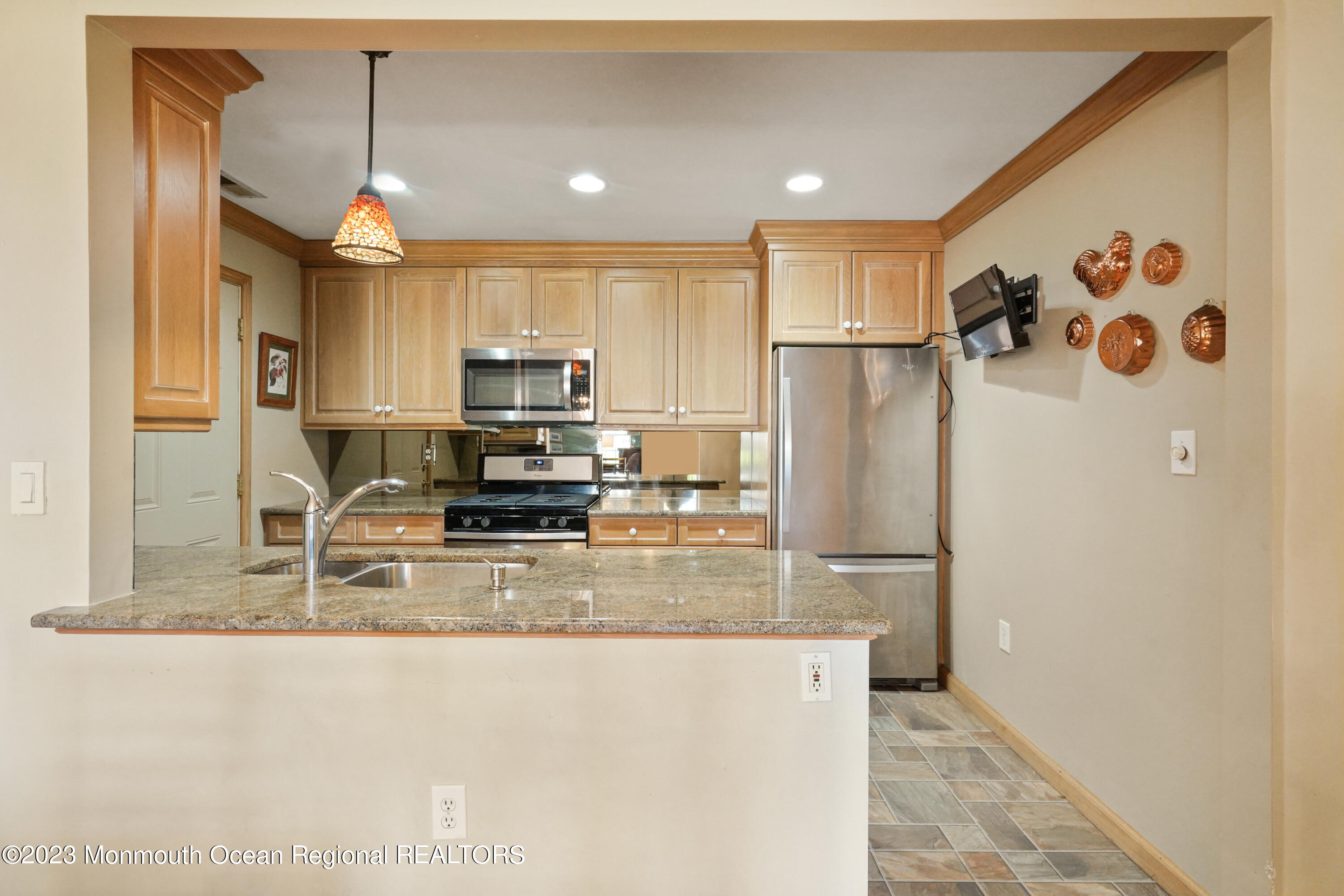 29 Racquet Road Wall, NJ 07719 - Photo 12 of 23 a kitchen with stainless steel appliances granite countertop a refrigerator a sink and a stove