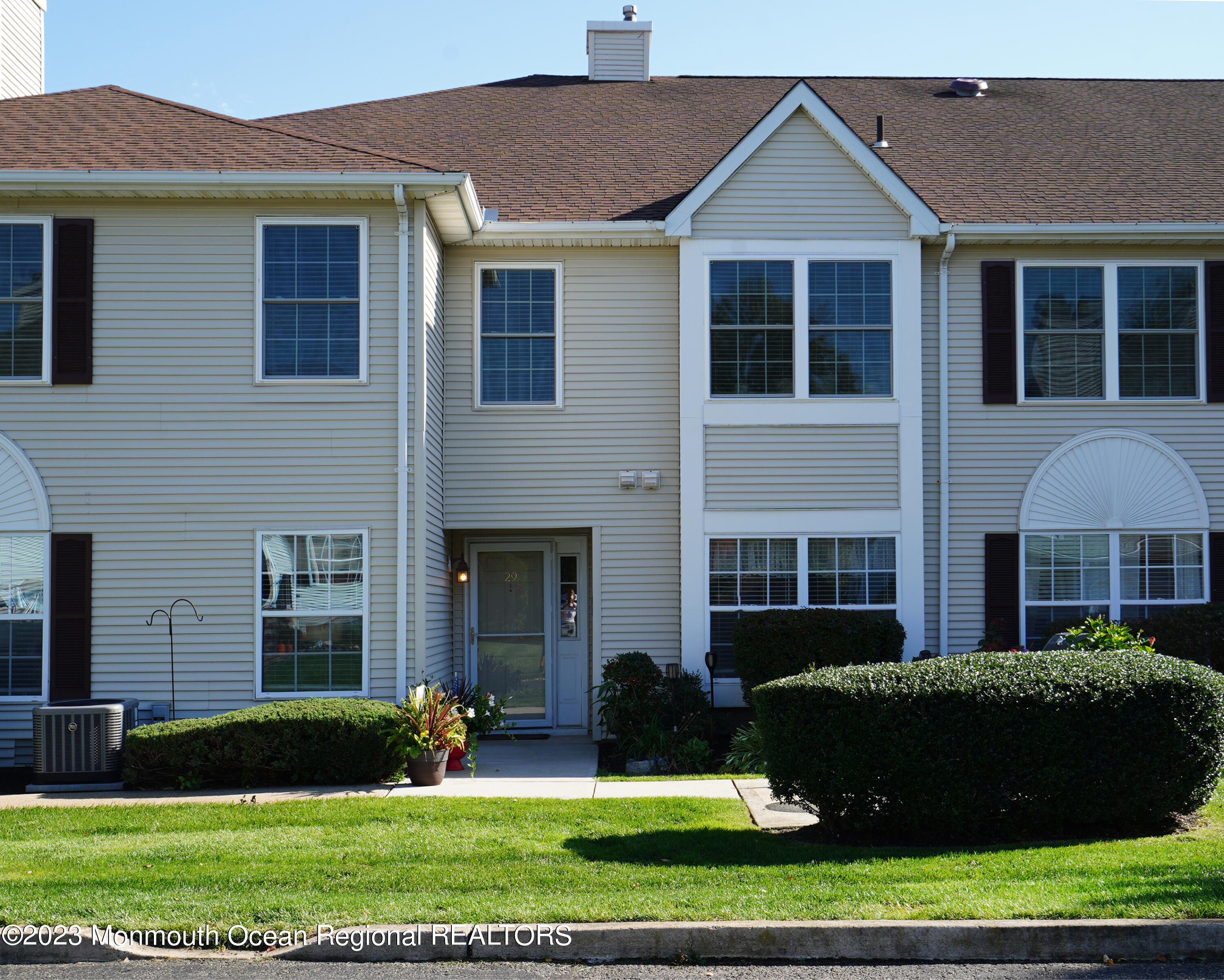 29 Racquet Road Wall, NJ 07719 - Photo 2 of 23 a front view of a house with a yard and plants