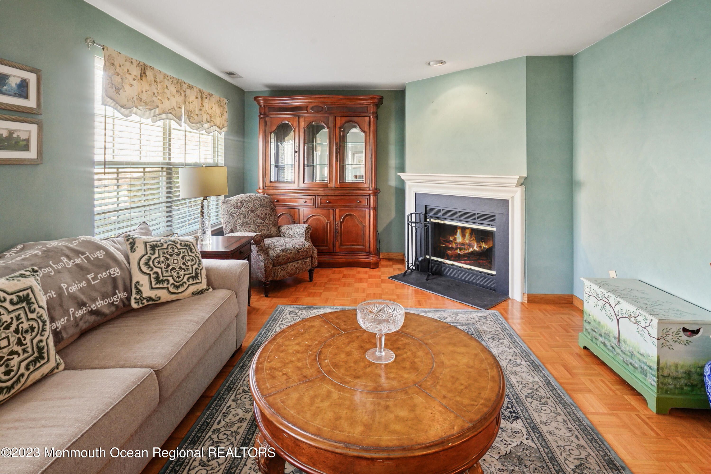 29 Racquet Road Wall, NJ 07719 - Photo 21 of 23 a living room with furniture a fireplace and a large window