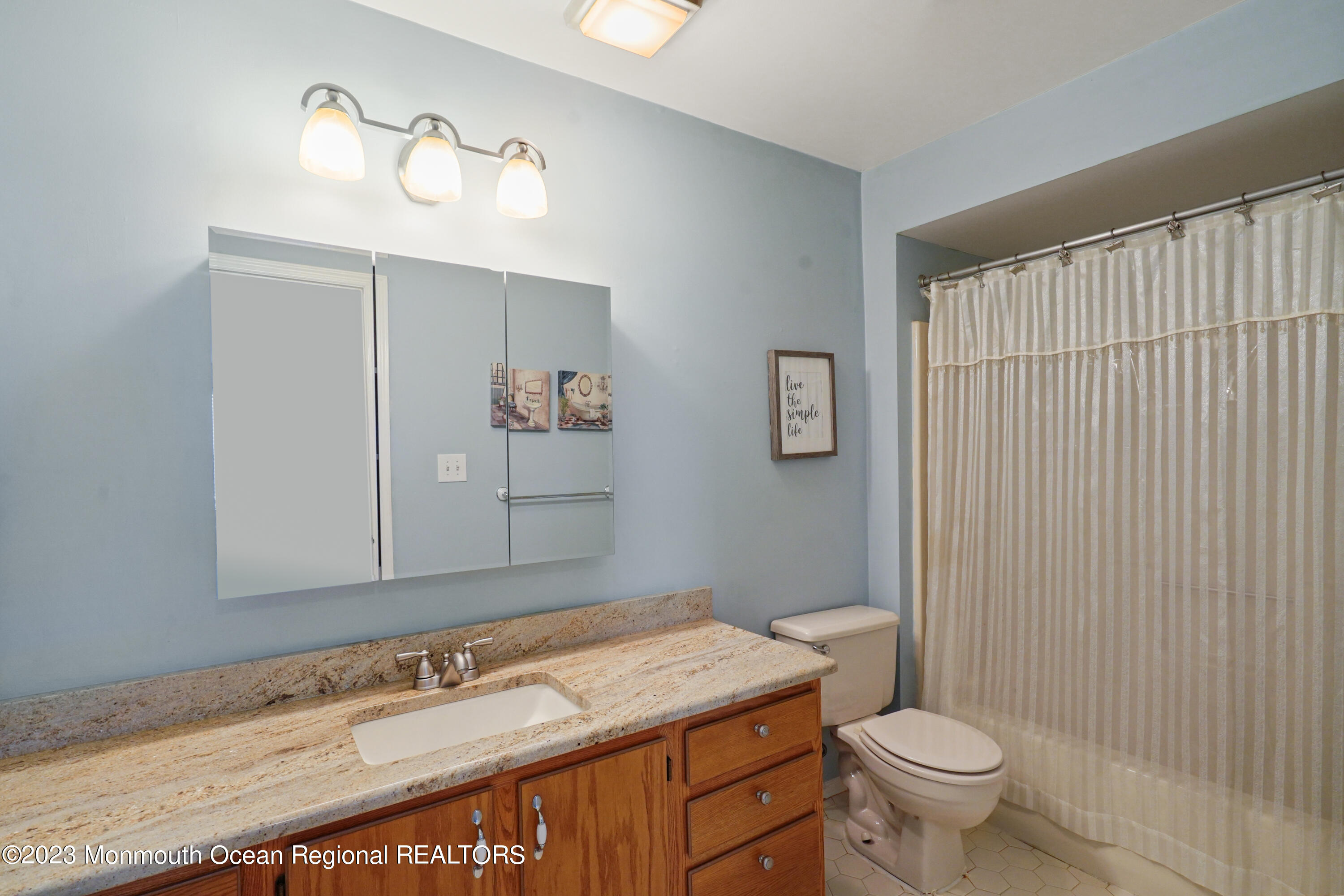 29 Racquet Road Wall, NJ 07719 - Photo 23 of 23 a bathroom with a granite countertop sink toilet and mirror