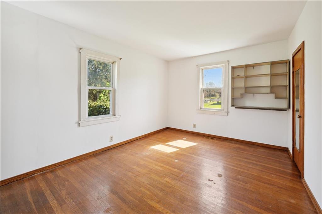 564 Rte 119 Highway North Indiana, PA 15701 - Photo 18 of 25 an empty room with wooden floor and windows