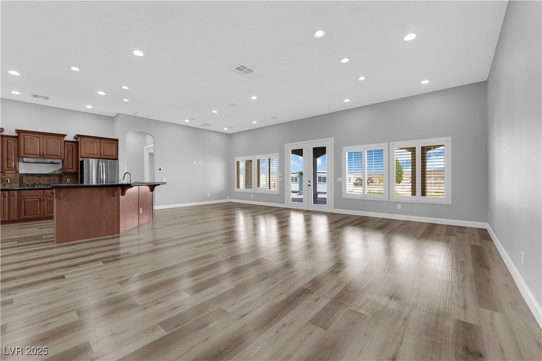 1415 Curohee Street Moapa, NV 89025 - Photo 14 of 54 Unfurnished living room with recessed lighting, light wood-style floors, and arched walkways
