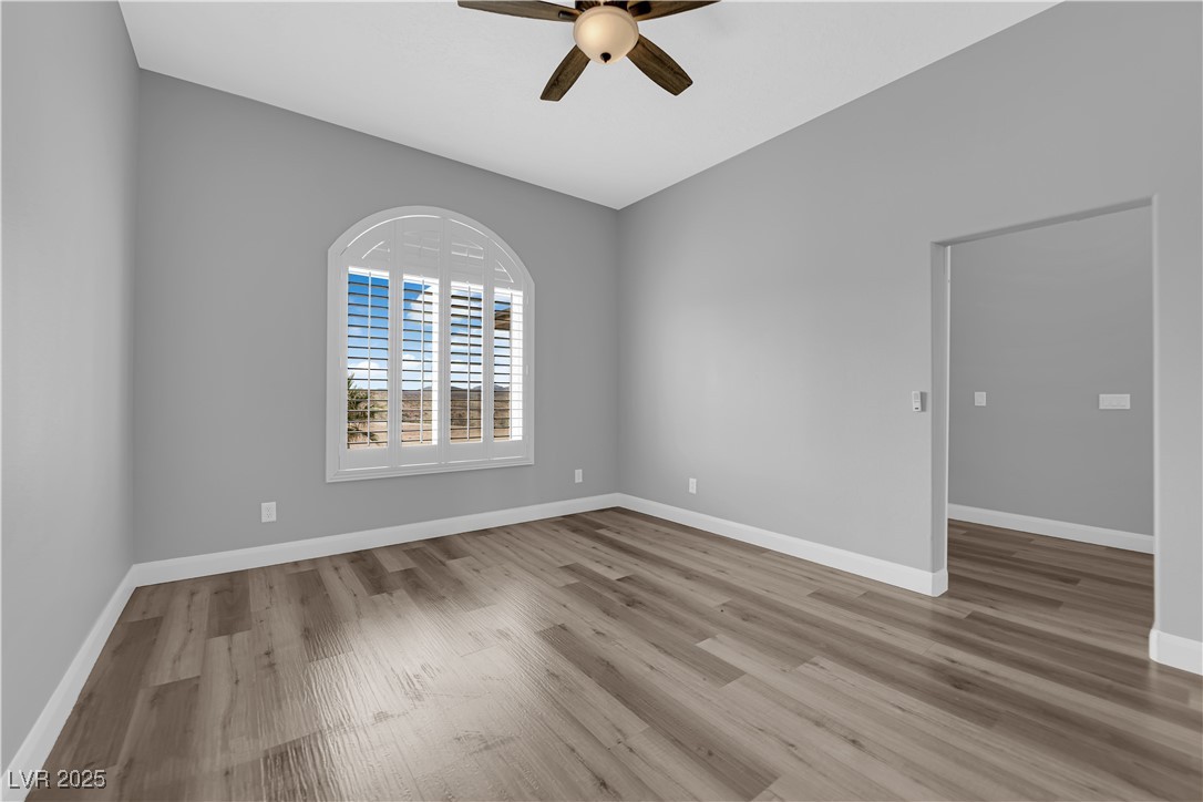1415 Curohee Street Moapa, NV 89025 - Photo 15 of 54 Empty room with light wood-type flooring and a ceiling fan