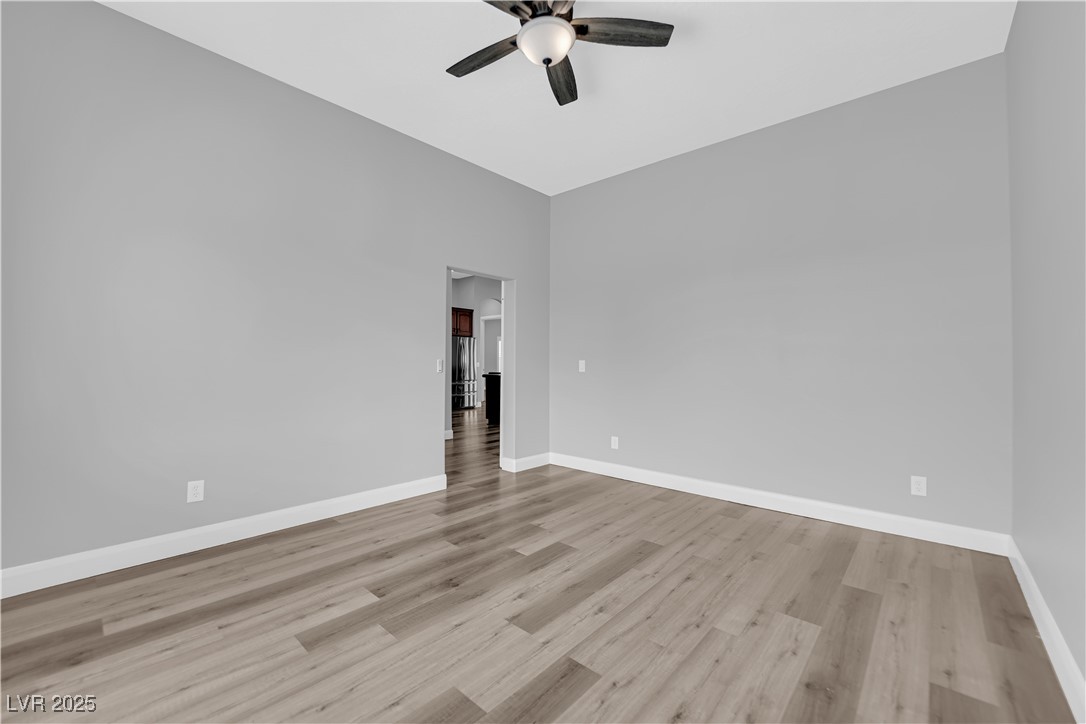 1415 Curohee Street Moapa, NV 89025 - Photo 16 of 54 Empty room featuring light wood-style flooring and ceiling fan