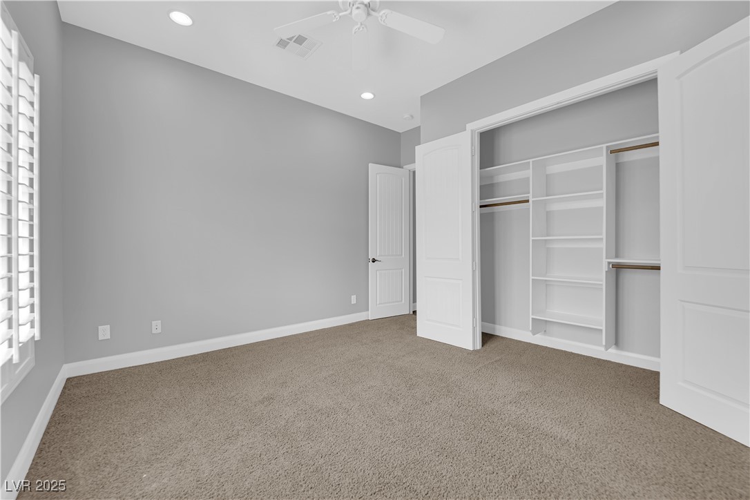 1415 Curohee Street Moapa, NV 89025 - Photo 19 of 54 Unfurnished bedroom with light carpet, recessed lighting, a closet, and a ceiling fan