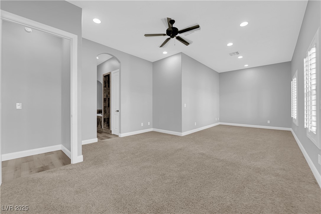 1415 Curohee Street Moapa, NV 89025 - Photo 24 of 54 Unfurnished room with light carpet, recessed lighting, arched walkways, and a ceiling fan