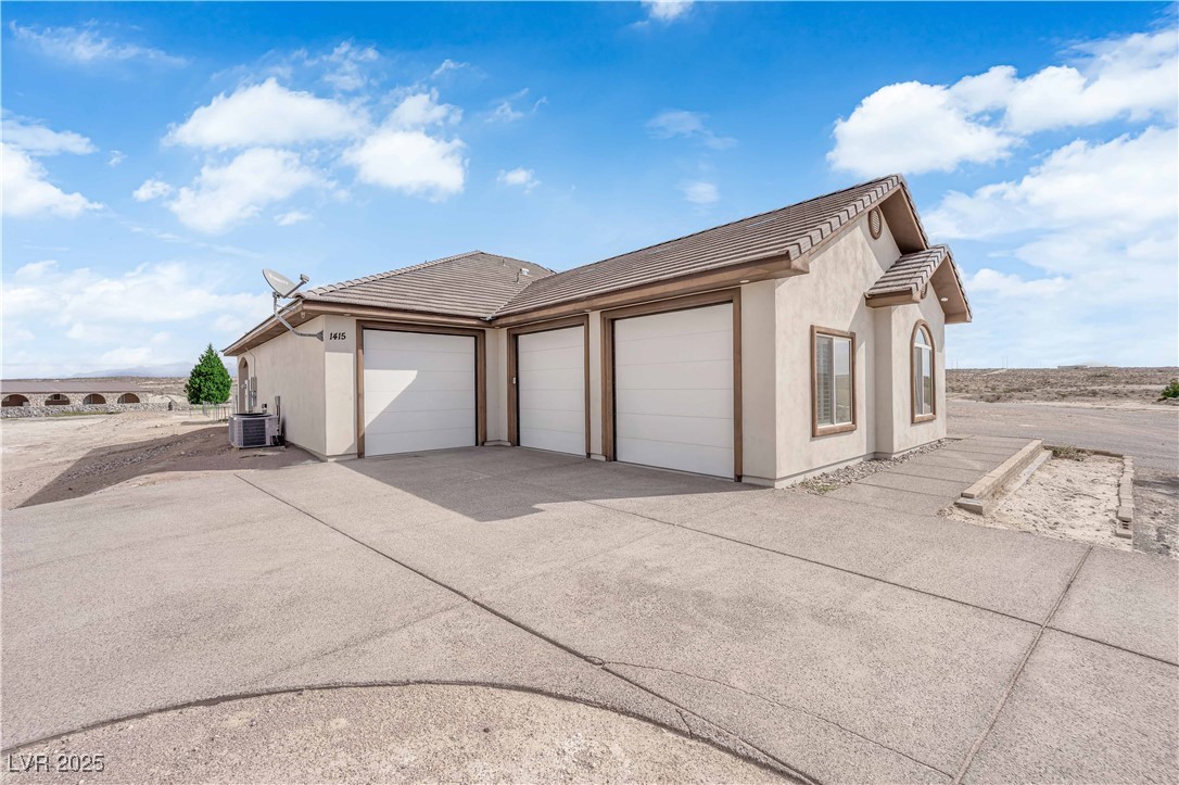 1415 Curohee Street Moapa, NV 89025 - Photo 25 of 54 Garage featuring concrete driveway