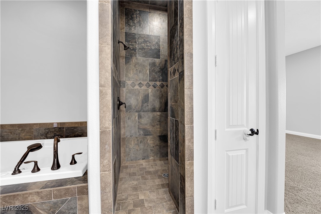 1415 Curohee Street Moapa, NV 89025 - Photo 31 of 54 Bathroom featuring a shower stall, a garden tub, and carpet