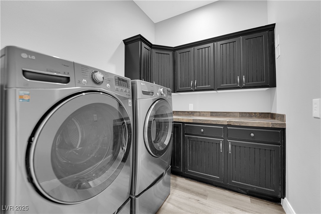 1415 Curohee Street Moapa, NV 89025 - Photo 32 of 54 Washroom featuring light wood-type flooring, cabinet space, and independent washer and dryer