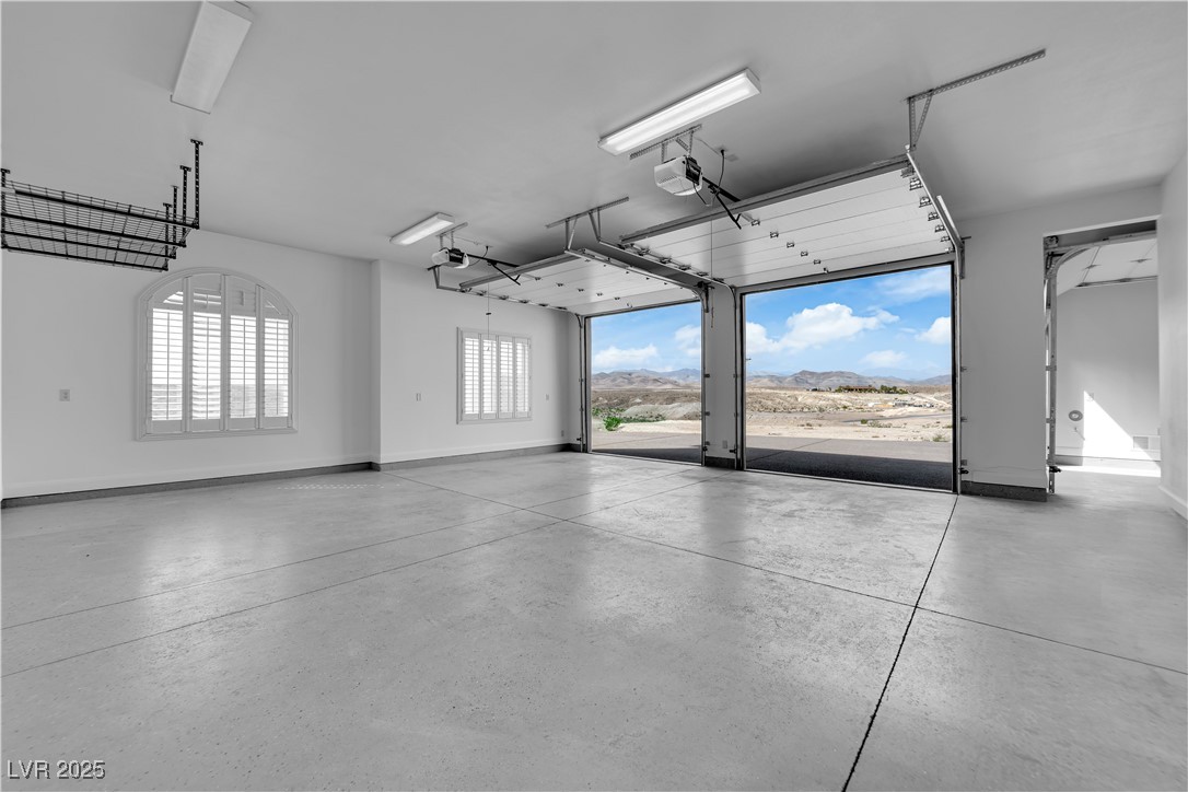 1415 Curohee Street Moapa, NV 89025 - Photo 35 of 54 Garage with a mountain view and a garage door opener