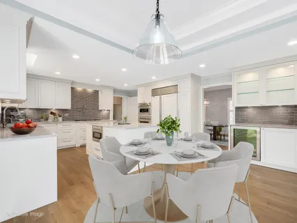 a kitchen with stainless steel appliances granite countertop a kitchen island a stove a cabinets a sink and a dining table