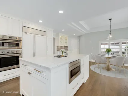a kitchen with appliances a sink and cabinets