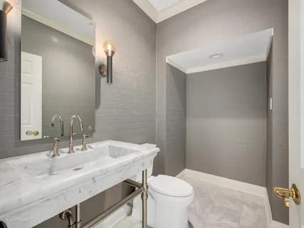 a bathroom with a sink toilet and a mirror