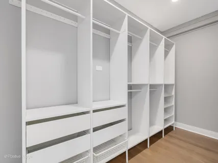 a view of walk in closet with empty racks