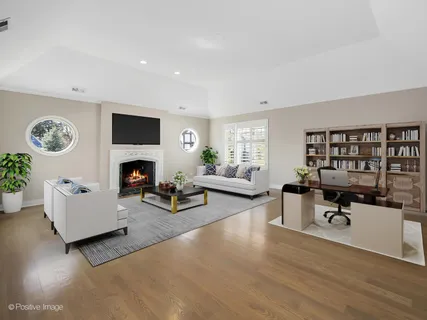 a living room with furniture a fireplace and a table