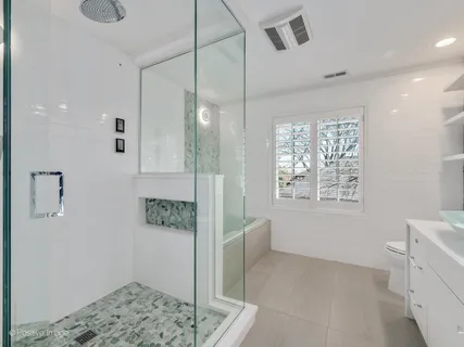 a bathroom with a bathtub and shower