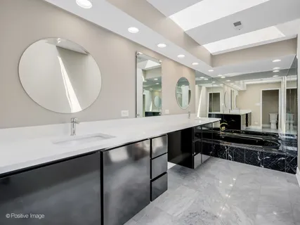 a large bathroom with a large tub and sink