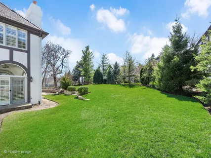 a view of a house with a yard and sitting area