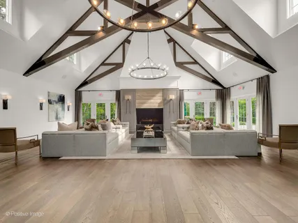 a living room with fireplace furniture and a large window
