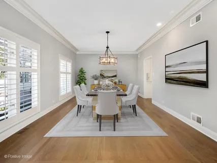 a dining room with furniture a window and a chandelier