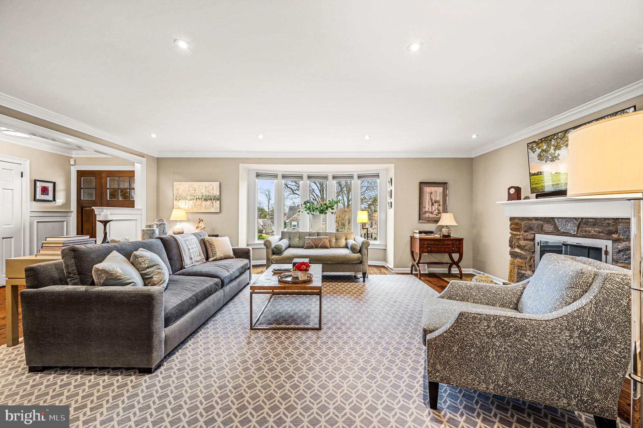 43 Crestline Road Wayne, PA 19087 - Photo 11 of 48 a living room with furniture floor to ceiling window and a fireplace