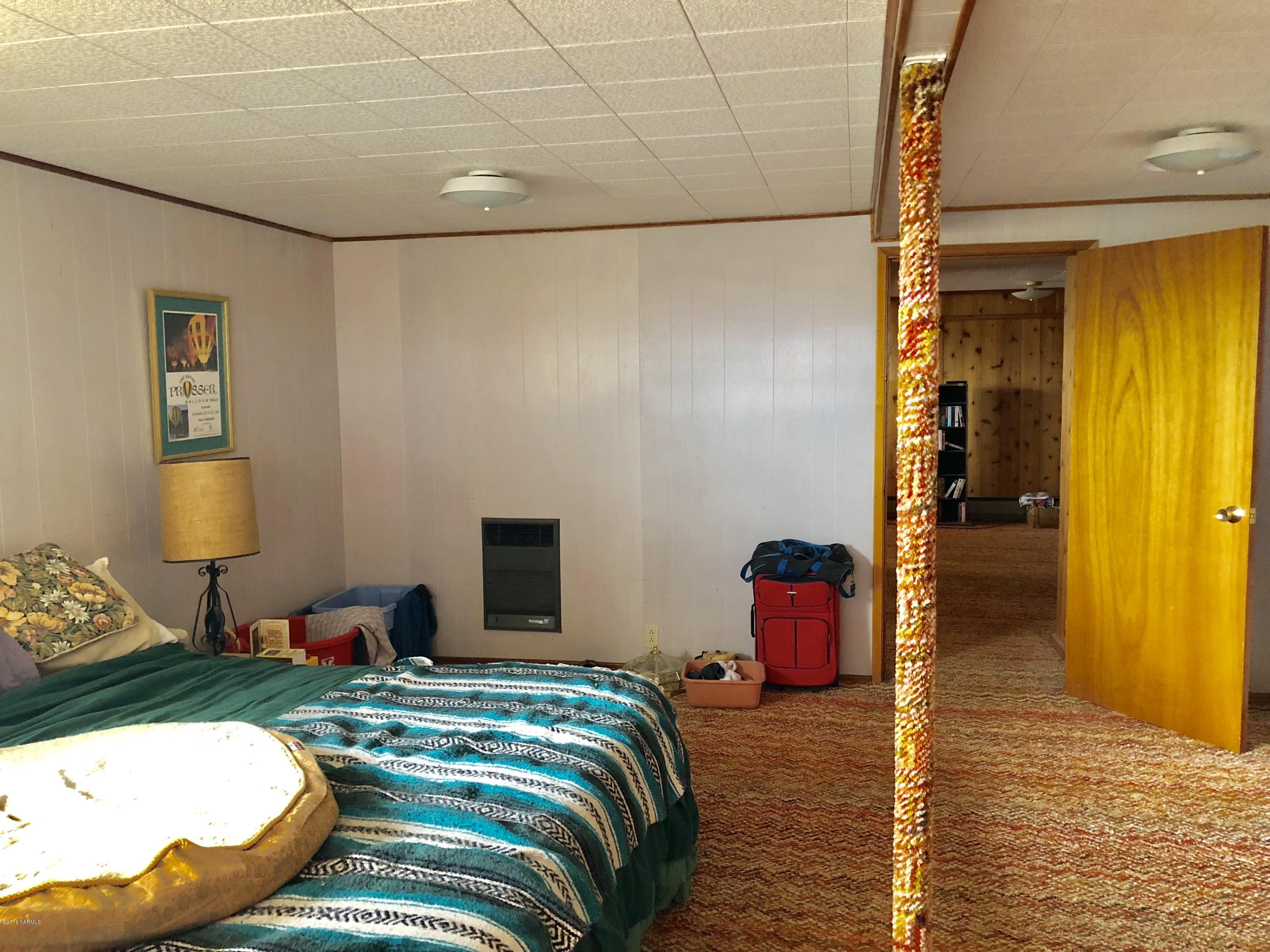 16573 Branch Road Harrah, WA 98933 - Photo 23 of 33 a bedroom with a bed and wooden floor