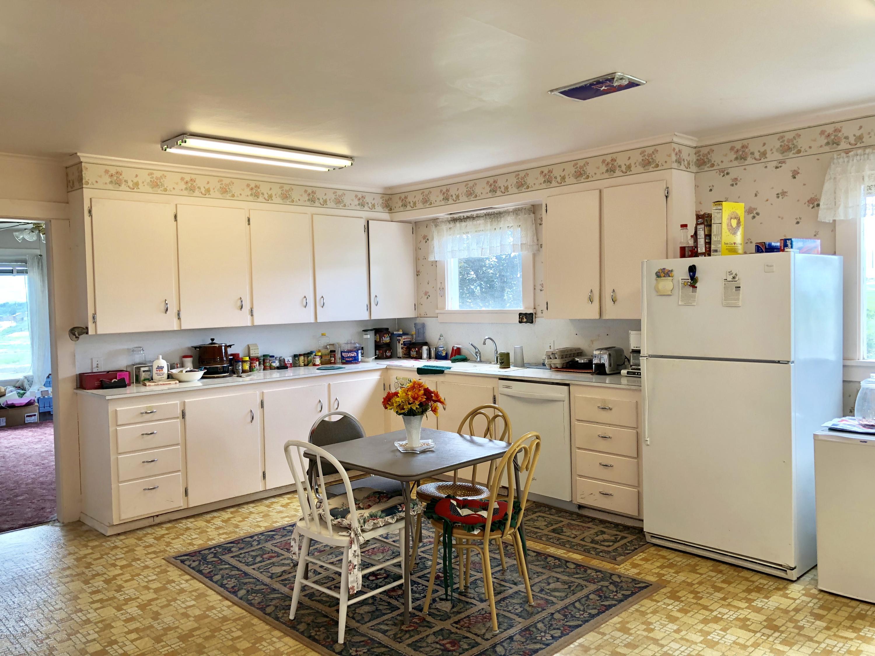 16573 Branch Road Harrah, WA 98933 - Photo 6 of 33 a kitchen with a refrigerator a table and chairs in it