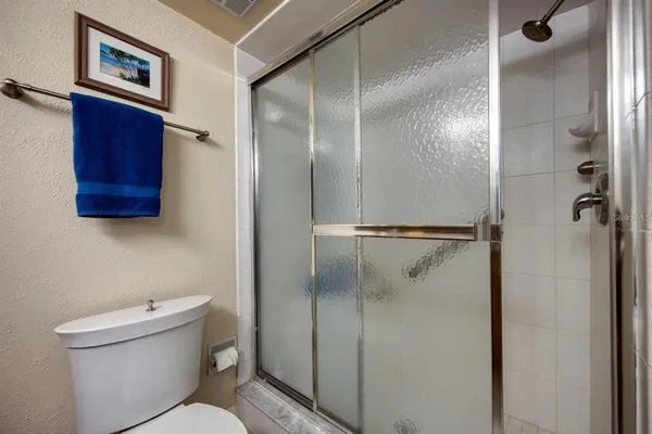 a bathroom with a toilet and a shower