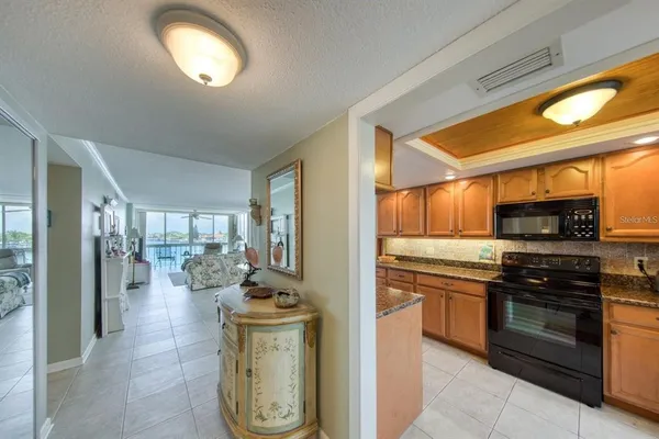 a kitchen with stainless steel appliances granite countertop a stove and cabinets