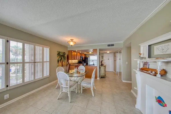 a dining room with furniture and a floor to ceiling window