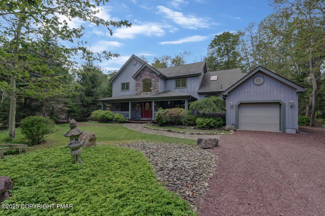 a front view of a house with a yard and trees