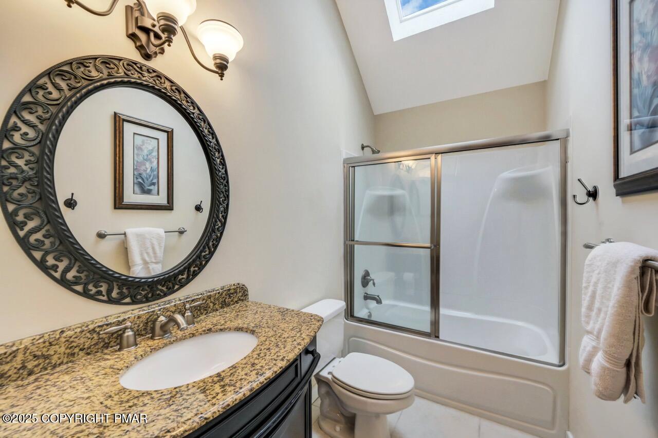 1179 Manor Hill Road Pocono Pines, PA 18350 - Photo 23 of 28 a bathroom with a granite countertop toilet sink and mirror