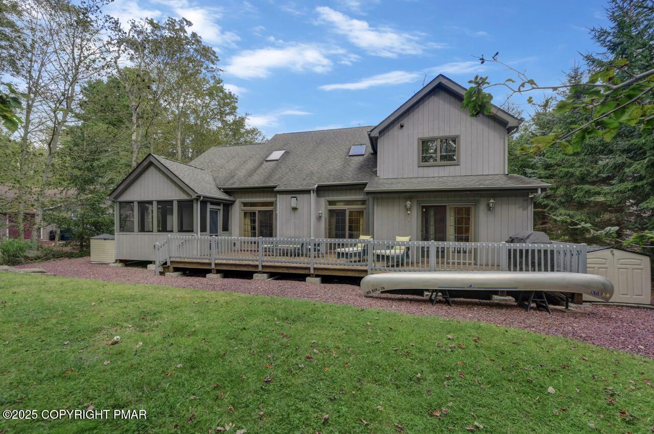 1179 Manor Hill Road Pocono Pines, PA 18350 - Photo 26 of 28 a view of a house with a yard and deck