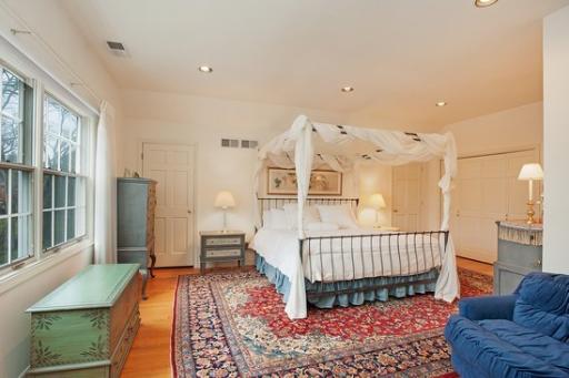 2045 Winnetka Road Northfield, IL 60093 - Photo 13 of 16 a spacious bedroom with a bed a couch and dresser